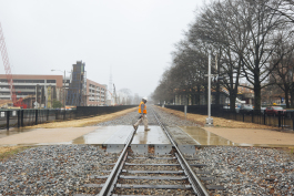 A construction worker walks across the Southern Avenue tracks near the University of Memphis campus at the heart of the University District. (Ziggy Mack)