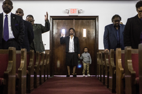 The congregation at Beulah Baptist raises their hands during worship. (Andrea Morales)