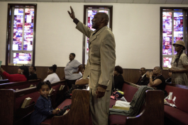 Jimmy Garner raises his hand during the Sunday service at Beulah Baptist. (Andrea Morales)