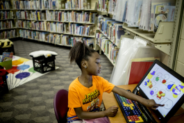  Janiya, 8, uses one of the computers in the kids’ corner at the Cornelia Crenshaw Library. 