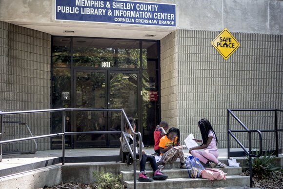 Kids hang out on the stoop of the Cornelia Crenshaw Library.