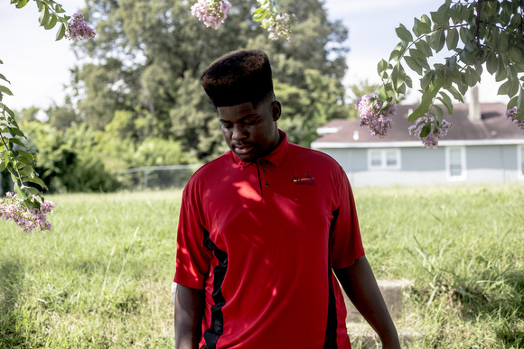 Demarquis, 16, stands for a portrait along Jackson Avenue.