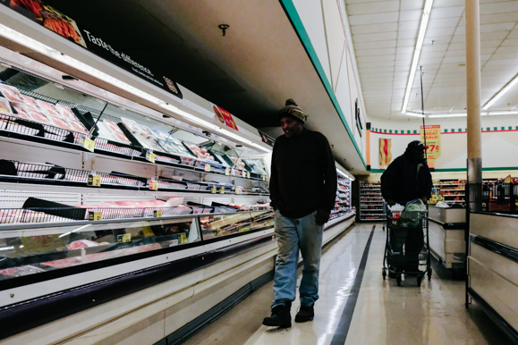 Two patrons of the Orange Mound Kroger browse the meat aisle. (Brandon Dahlberg)