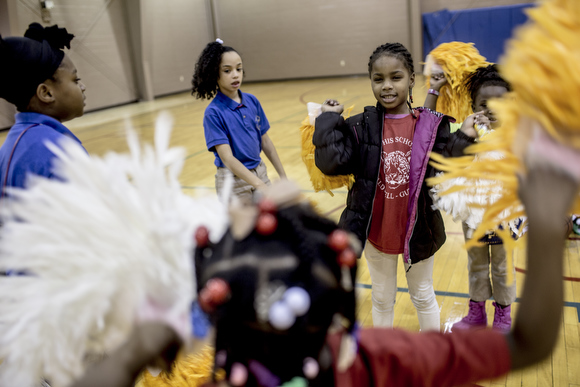 Girls in the Dave Wells Community Center's cheer squad play with their pompoms before practice. 