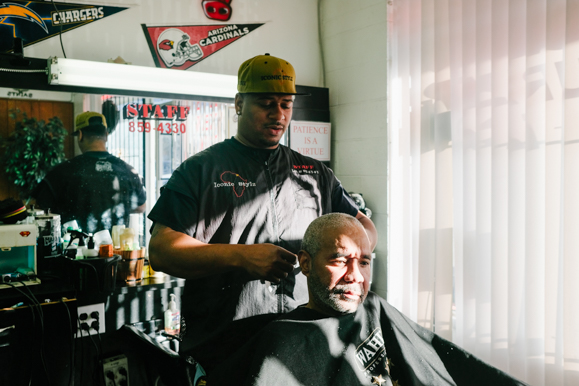 Staff Jones attends to a customer at his barbershop, Iconic Stylz. (Brandon Dahlberg) 