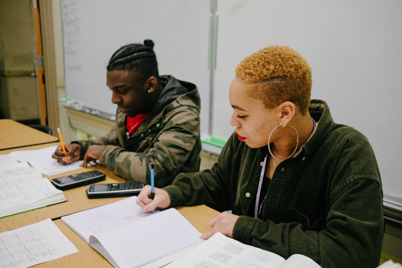 Taiya Hill, 17,  and Dwayne Maxwell, 16, work on math homework at Whitehaven High School.