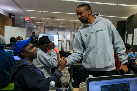 Meka Egwuekwe, co-founder and executive director of CodeCrew, speaks to coding students at the Benjamin L. Hooks Central Library. (Brandon Dahlberg)  