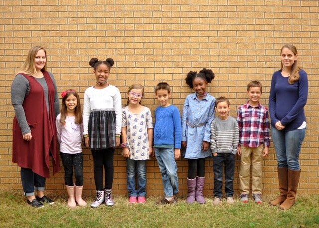 Sarah Gong (far right) and Kristin Thompson (far left) pose for a class picture with Sycamore School's second and third graders. They co-teach the combined grades. (Susan Kizzee)