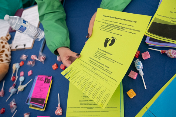 Brianna Amaba, a student at the University of Memphis, presents a flyer with information about the Pregnant Moms' Empowerment Program. (Brandon Dahlberg)