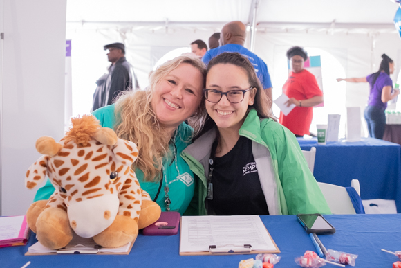 Candice Crossnene and Brianna Amaba, of Pregnant Moms' Empowerment Program with the University of Memphis, pose with a stuffed animal. (Brandon Dahlberg)