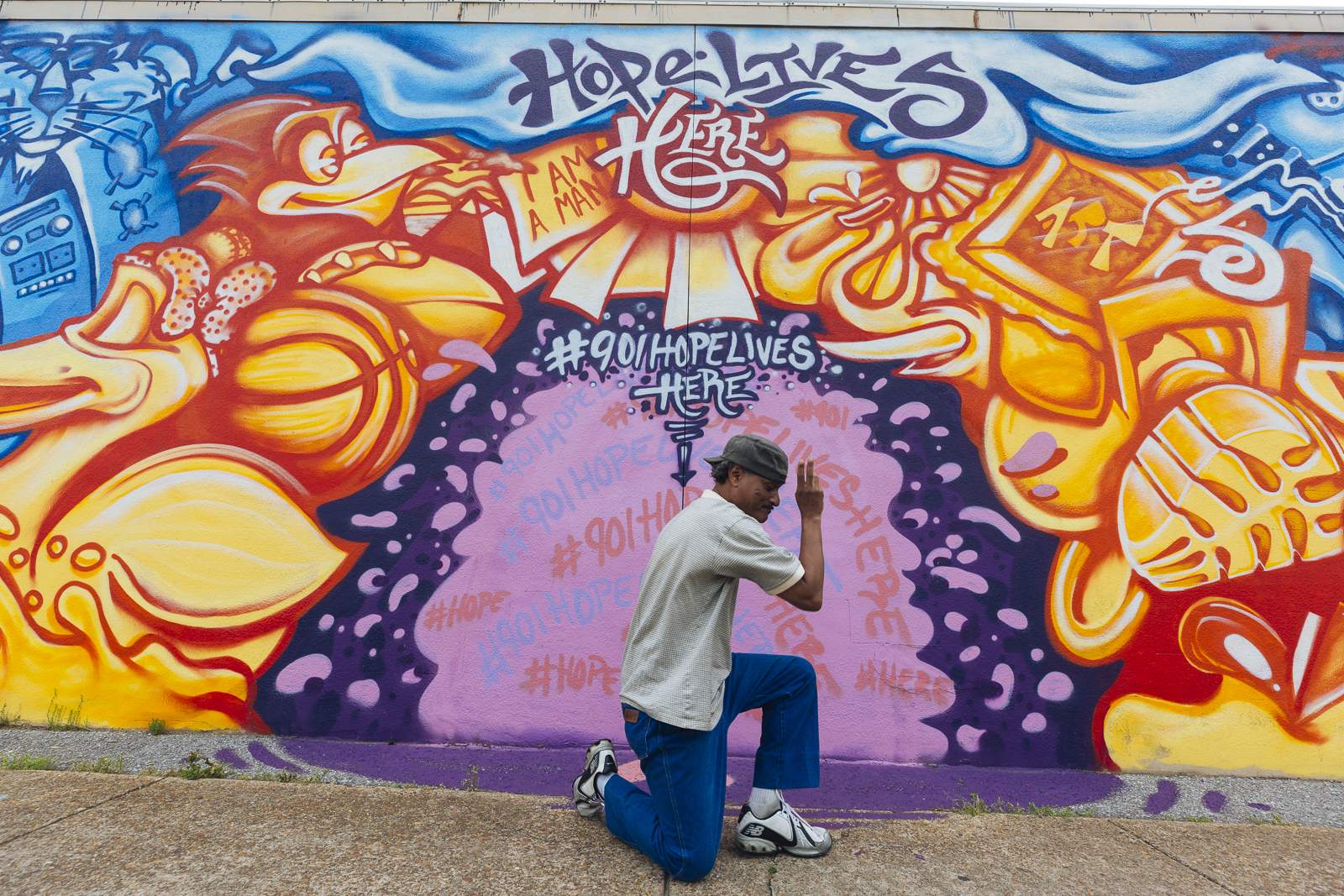 Local musician "Morris" poses in front of a mural by artist Toonkey Berry. (Ziggy Mack)