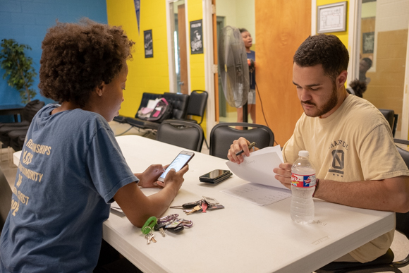 Rosa Chapple (left) and Darnell Gibson (right) prepare for their responsibilties at Oasis of Hope. (Brandon Dahlberg)