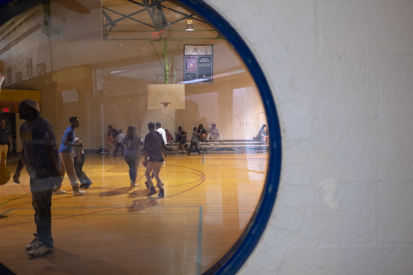 Students and volunteers interact on the basketball court during MAM's end of the year celebration inside the Greenlaw Community Center. (Brandon Dahlberg)