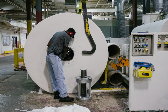 A KTG employee prepares a parent roll for the next stage of manufacturing. (Brandon Dahlberg)