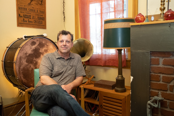 Chris Davis sits in the living room of the Dave Wells House. (Brandon Dahlberg)