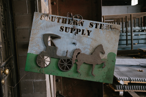 This sign, featuring a horse drawn carriage, was made by one of the workers at Southern Steel Supply. (Brandon Dahlberg)
