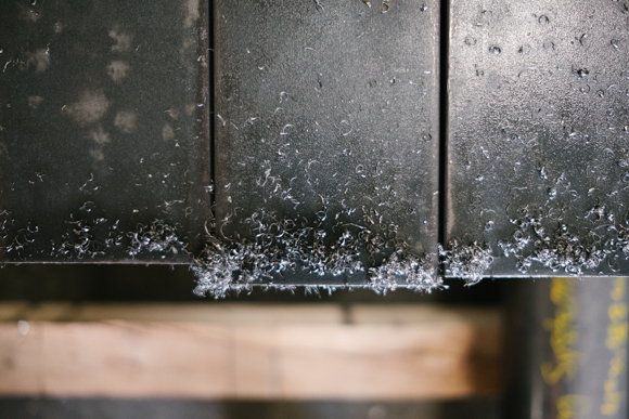 Metal shavings have accumulated on recently cut steel bars at Southern Steel. (Brandon Dahlberg)