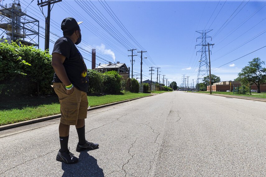 Frank Johnson looks towards North Memphis' Penn A Kem, LLC  chemical plant on the left hand side of the road. On the right is Douglass High School. (Ziggy Mack)