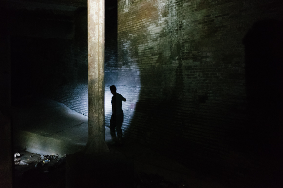 A member of the group investigates brickwork in a large retention area, part of the Gayoso Bayou. (Brandon Dahlberg)