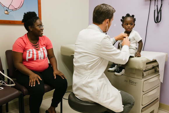 Kenya Silas looks on as Dr. Jason Yaun treats her son, Amir Gooden, at LeBonheur Children's Hospital. (Brandon Dahlberg)