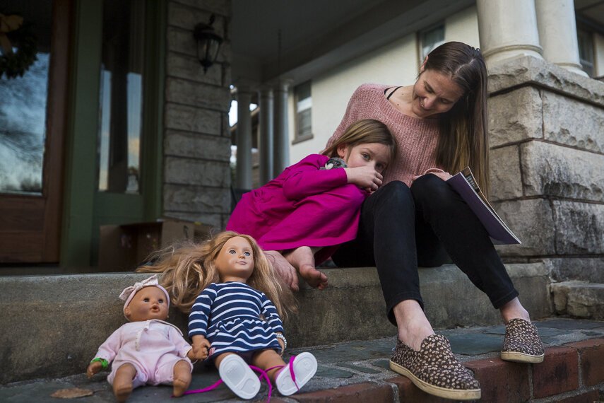 Victoria Kintner-Duffy sits on her porch in Central Gardens with her daughter. Her daughter is 6 1/2 years old and was diagnosed with autism at 4. Kintner-Duffy said it's been a years-long process to get a diagnosed and proper support. (Ziggy Mack) 