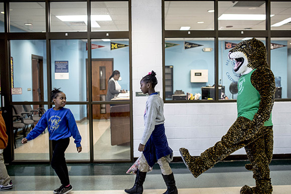 Students at Memphis Scholars Caldwell-Guthrie play with their school mascot "Jiggy."