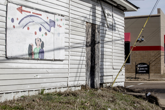 A welcome sign to the Smokey City neighborhood  stands on Jackson Avenue.