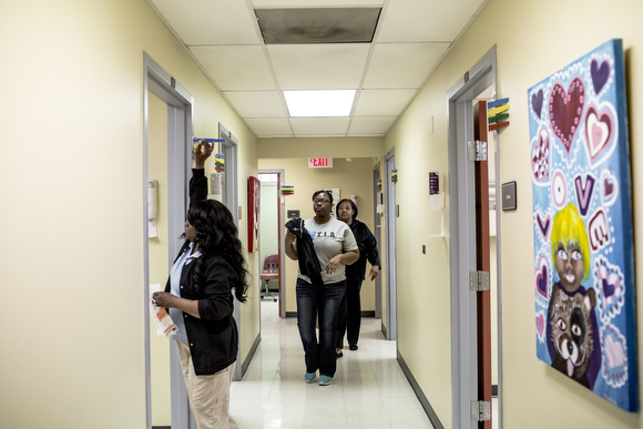 Christine Jones and her mother Irma (behind) walk down the hall toward an exam room while being seen at the Guthrie Primary Care Clinic in Smokey City, North Memphis. (Andrea Morales, 2017).  