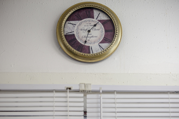  A clock with the message "I can do all things through Christ, who strengthens me," hangs on the wall at the Handy Spot, a barber shop on Vollentine Avenue in Klondike. 