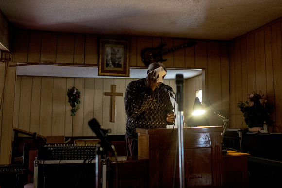 Pastor Eddie Brooks wipes his brow during the sermon at Pillar of Jerusalem church in Smokey City. 