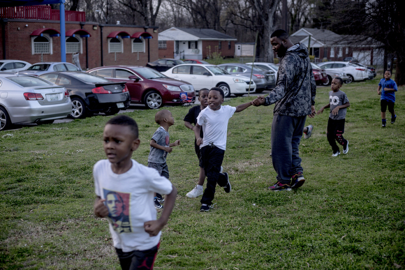  Jetaime Wiggins catches a high five from Chavis Daniels while running laps at the Katie Sexton Community Center in Klondike during practice for the North Memphis Steelers. 