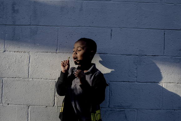  Eljohn White, 6, blows on a dandelion while hanging out at the John Dustin Buckman Boys & Girls Club of Greater Memphis.