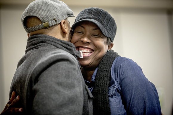 Angela Adair hugs her husband Robert during Sunday service at Hope City Church in Caldwell-Guthrie's cafeteria in Smokey City. 
