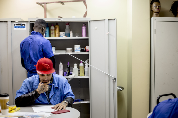 Stevo Seward works on classwork at The Barber School on Jackson Avenue in Klondike. 