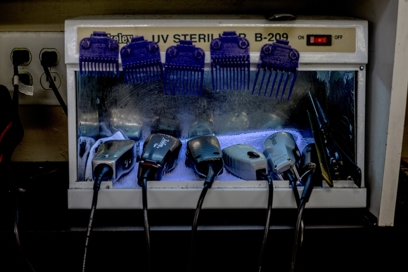 Clippers sit under a UV light at The Barber School on Jackson Avenue in Klondike. 