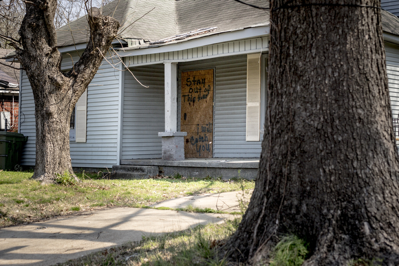 A boarded up home on Bellevue Boulevard in Klondike carries a message to deter break-ins. 