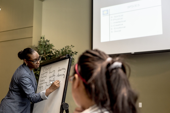 Joi Hibbler, an educator for Operation Smart Child, makes notes during a conversation in the prenatal program for expectant mothers at the Neighborhood Christian Center in Smokey City.