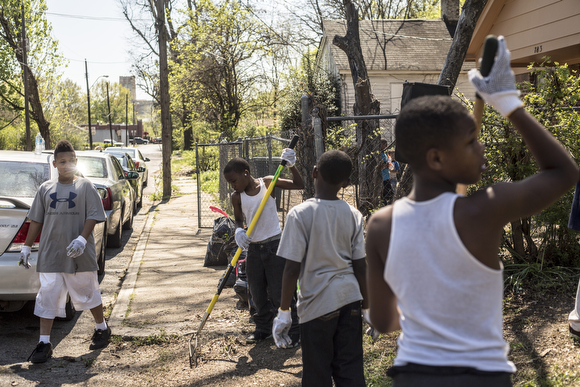  Folks from the community organization Crowning Our Youth, Inc. an anti-violence and youth oriented group, worked to clean up vacant lots along Randle Street in Klondike. 