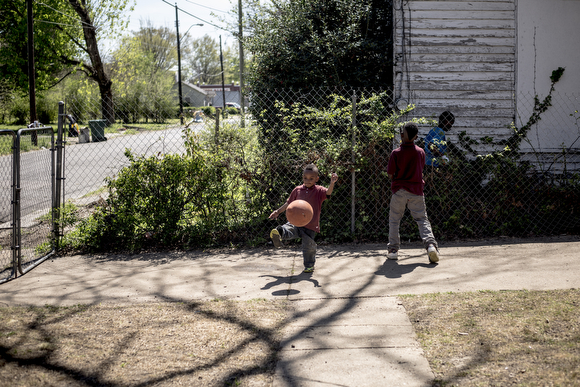  Folks from the community organization Crowning Our Youth, Inc. an anti-violence and youth oriented group, worked to clean up vacant lots along Randle Street in Klondike. 