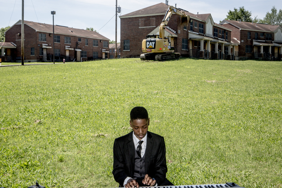 McKenly Carodine, 12, plays the piano during the City of Memphis ceremony announcing the demolition of Foote Homes. 