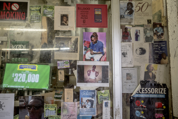 Photos of community members hang on the glass at Salem’s Market on Mississippi Avenue. The store has been open for decades in the neighborhood and has seen a significant slowing of business since Foote Homes closed and demolition started.
