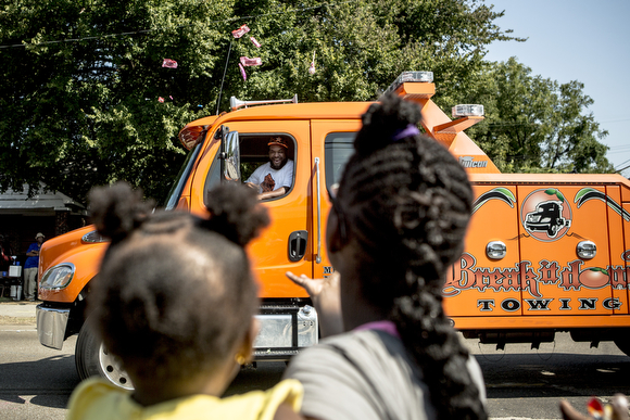 Break It Down Towing tosses candy out from their truck.