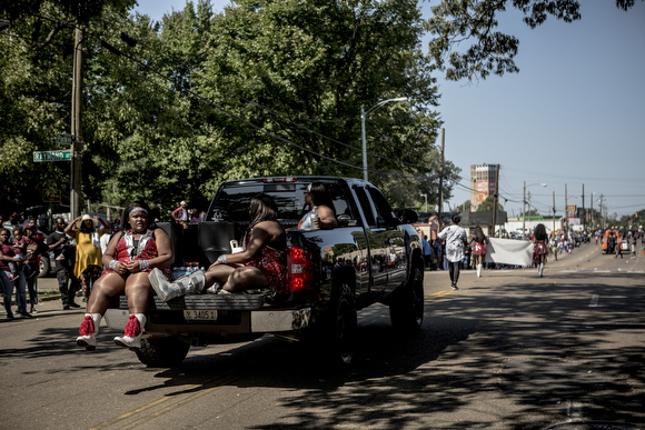 Majorettes from the Elite Starz of Nashville ride in a truck bed also carrying the group's music.