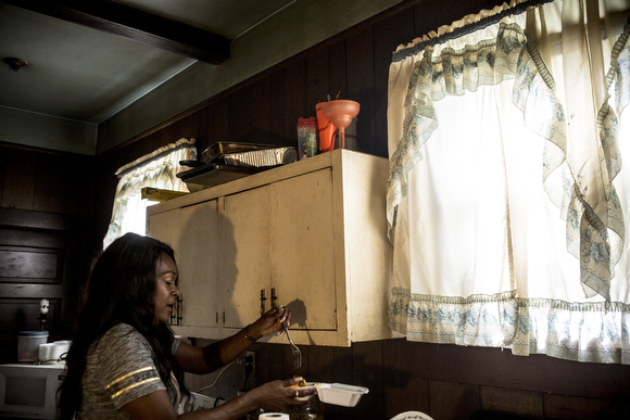 Deidra Tuggle, the Candy Lady of Orange Mound, serves up a nacho plate in her kitchen for her after school customers.