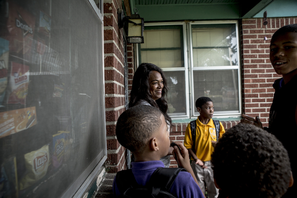 Kids start lining up at the home of Deidra Tuggle, the Candy Lady of Orange Mound.