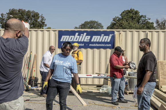 Volunteers work on setting up a foundation for a new playground on Wednesday morning at Circle of Success Learning Academy in South Memphis. 