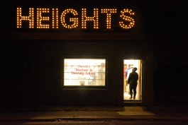 The vacant barber shop at 769 National Street was topped with a sign made from repurposed Christmas lights and the boards that once shuttered the windows. (Markus Mueller)