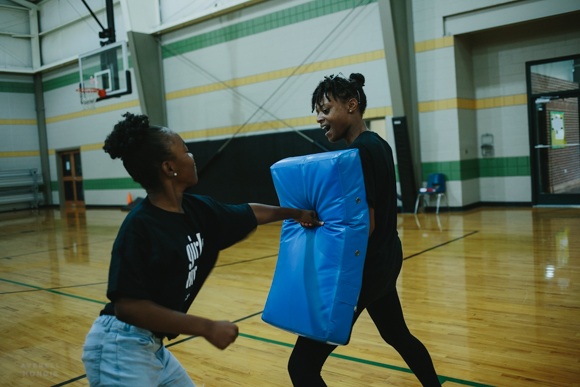 Girls Inc. counselor Brittney Wiliams instructs the girls in self-defense exercises.