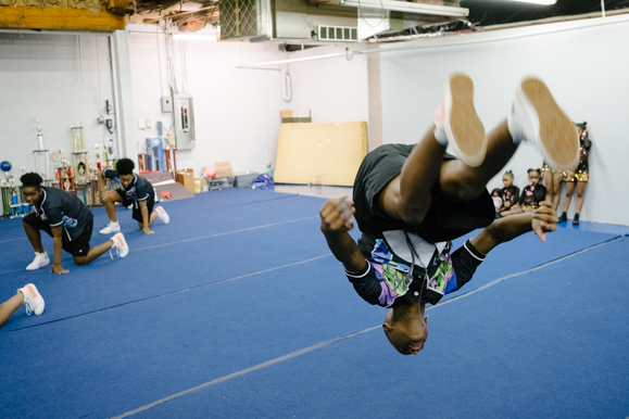 One of the members of the Memphis Area Youth Association juniors, which includes 8th through 10th graders, performs a flip. (Brandon Dahlberg)