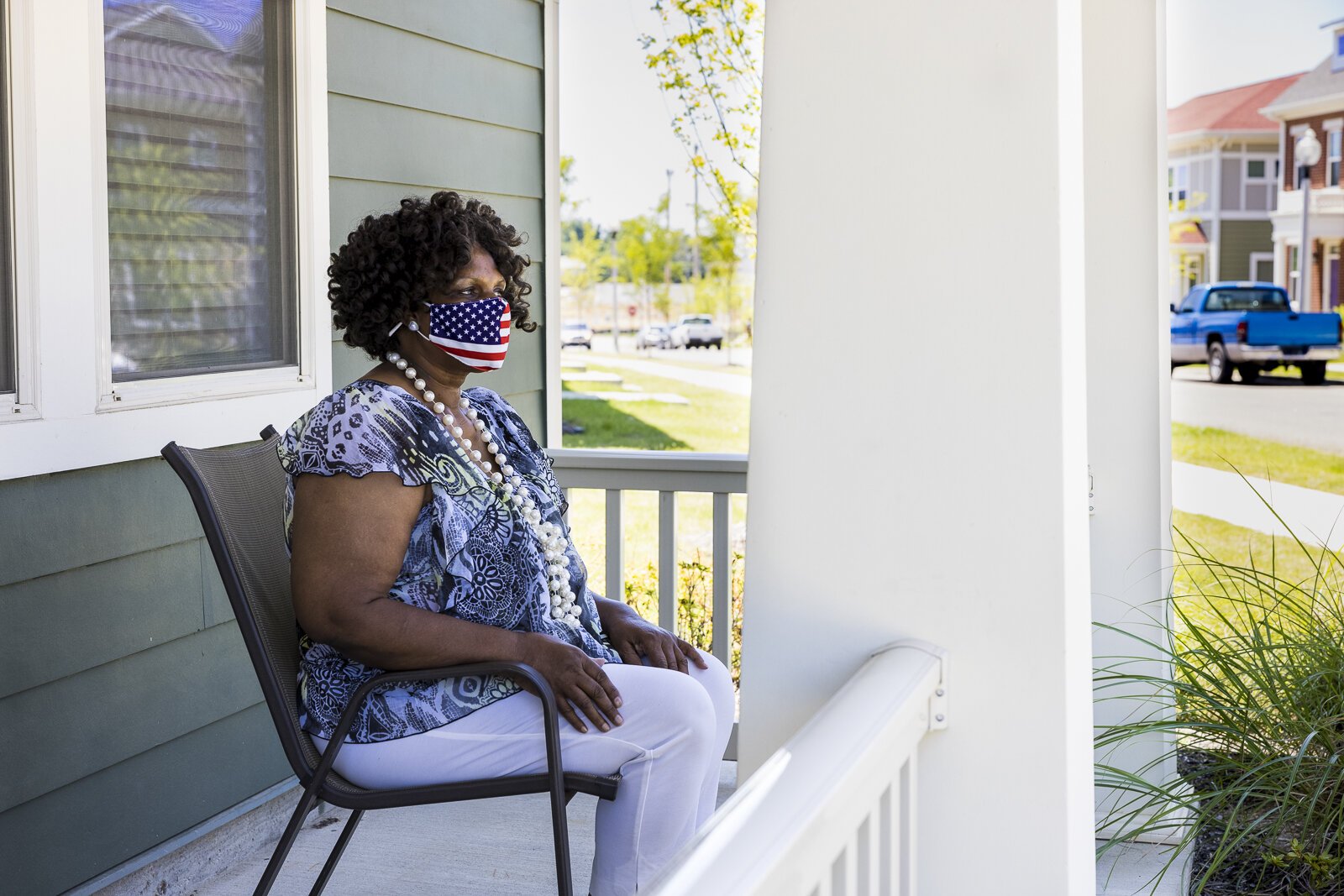 Denise Oher sits on a neighbor's porch and looks out over the new Foote Park at South City development. Oher is a former Foote Homes resident who has chosen to return after being displaced for the demolition of Foote Homes. (Ziggy Mack)